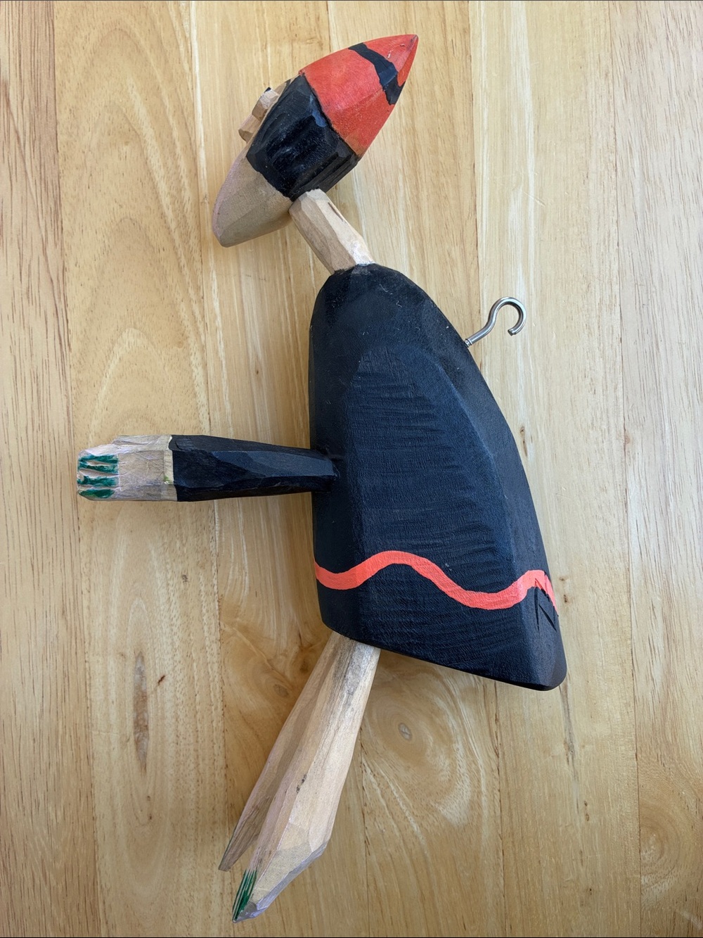 Strange hand carved folk art character with bland and orange clothes and a hook - Picture 3 of 13